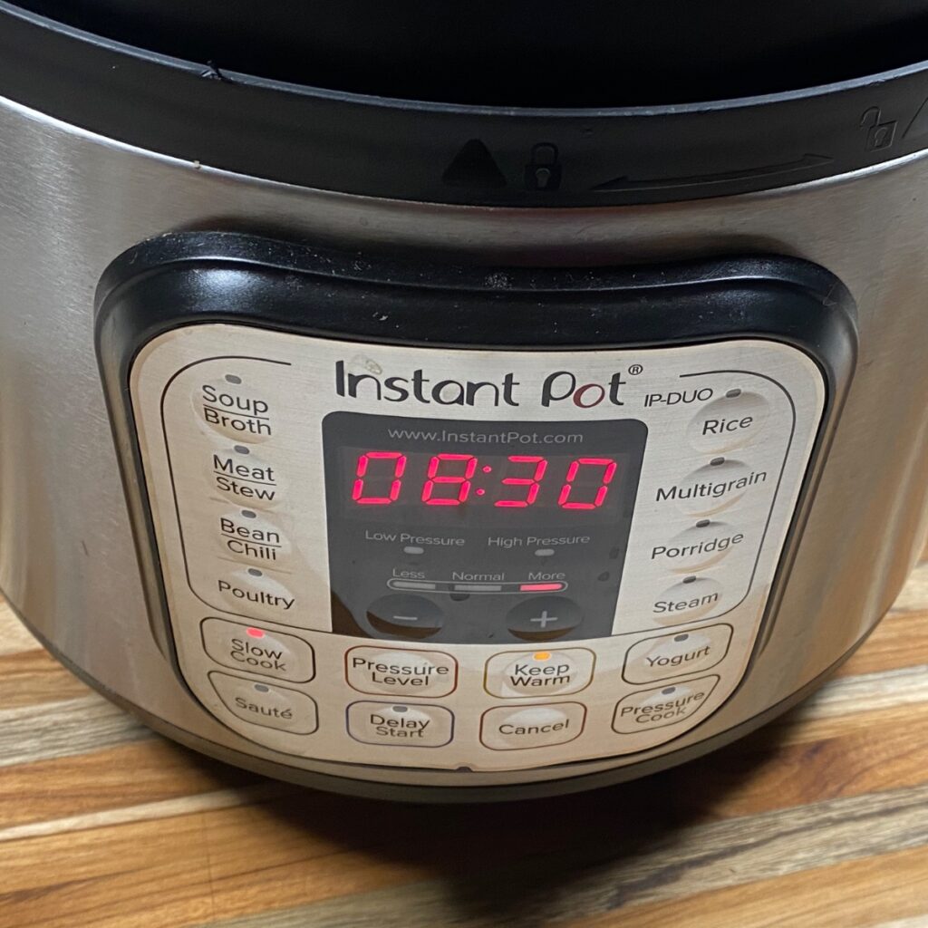 Instant Pot Ham and Bean Soup, showing the settings on the Instant Pot, which should be set to slow-cook on the highest setting.