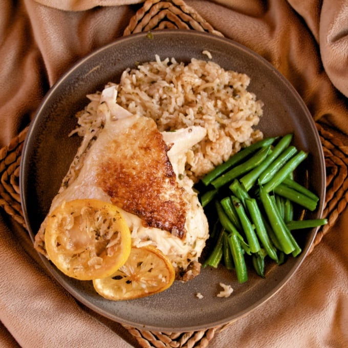 One-Pan Meyer Lemon Chicken and Rice on a plate with a side of green beans.