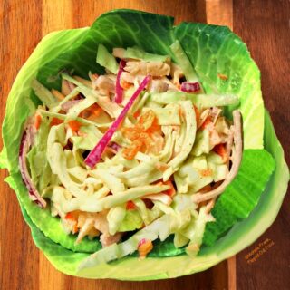 Top view of Easy, Zippy Coleslaw in a bowl made of cabbage leaves.