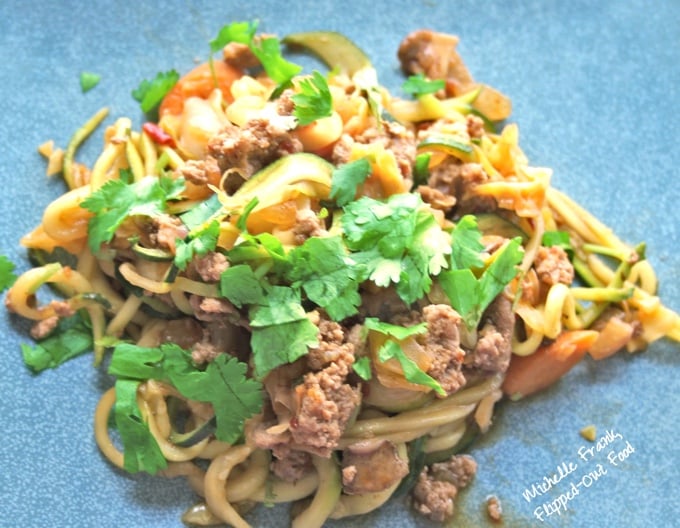 Vegetable-Turkey Lo Mein with Zoodles: an individual serving scattered with cilantro, presented on a blue plate.