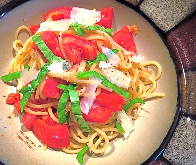 Tomato-Basil Pasta serving in a bowl. A healthy meal that makes your garden (or Farmer's Market) tomatoes shine! #pasta #healthyfood #tomatobasilpasta #healthyeating #quickmeal @FlippedOutFood