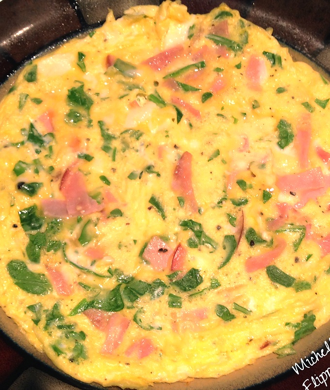 Using up leftovers: a ham frittata with leftover ham, herbs, and cheese.
