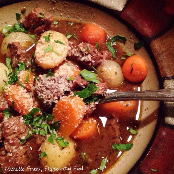 vintage beef stew serving in a decorative ceramic bowl, sprinkled with parsley.