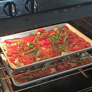 Slow-roasted tomato sauce: sliced tomatoes in pans, roasting in the oven with herbs, salt and pepper, garlic, and olive oil. #italianfood #marinarasauce #gardentomatosauce #tomatosauce #flippedoutfood #pastasauce via @FlippedOutFood