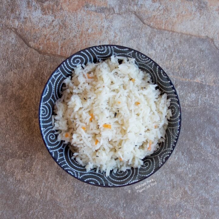 A serving of Coconut-Habanero Rice in a black bowl with white swirls.