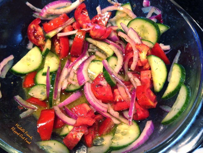 Cucumber-Tomato-Onion Salad in a glass bowl