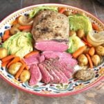 A platter of make-ahead corned beef and cabbage with a dollop of grainy mustard #irishfood #cornedbeef #cornedbeefandcabbage #saintpatricksday #comfortfood #crockpot #slowcooker