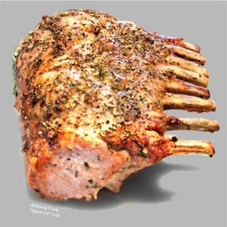 Golden-brown Herb-Roasted Rack of Pork resting after coming out of the oven.