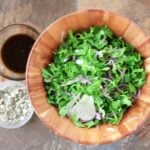 arugula-shaved fennel salad in wooden bowl