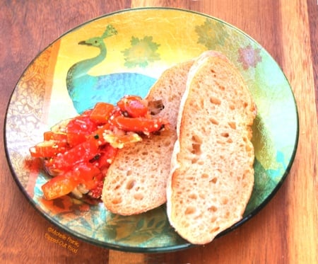 roast garlic red pepper bruschetta on a decorative plate, side view