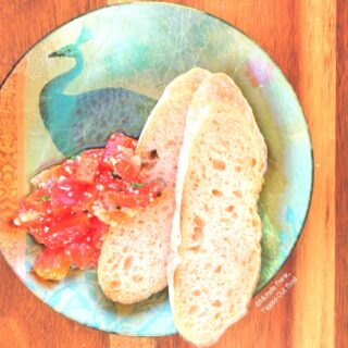 Roast Garlic-Red-Pepper Bruschetta, plated. The perfect appetizer for small gatherings or date night. The leftovers are wonderful as a no-cook sauce for pasta! #bruschetta #bruschettatopping #italianfood #appetizer #partyfood #datenight