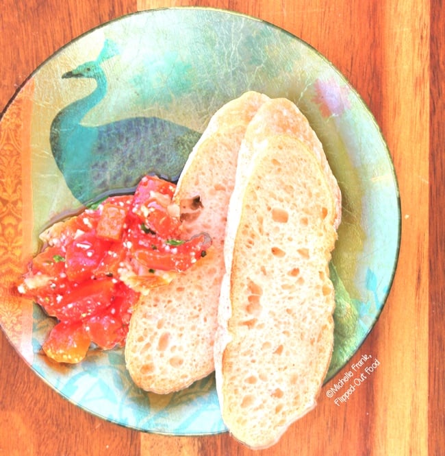 Roast Garlic-Red-Pepper Bruschetta, plated. The perfect appetizer for small gatherings or date night. The leftovers are wonderful as a no-cook sauce for pasta! #bruschetta #bruschettatopping #italianfood #appetizer #partyfood #datenight