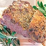 Date night prime rib for 2 resting on the cutting board with fresh herbs. #primerib #primeribroast #holidaydinner #valentinesdaydinner #datenight #romanticfood via @FlippedOutFood