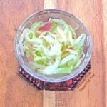 Piquant Cabbage-Onion-Bacon Sauté in a clear ramekin. A perfect side dish not only for pork chops, but for any roasted meat. #sidedish #sauteedcabbage #healthyfood