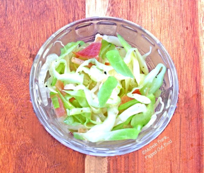 Piquant Cabbage-Bacon-Onion Saute in a clear ramekin. A delicious side dish for roasted meats—especially pork. #sauteedcabbage #friedcabbage #friedcabbageandbacon #bacon #cabbage #sidedish @FlippedOutFood