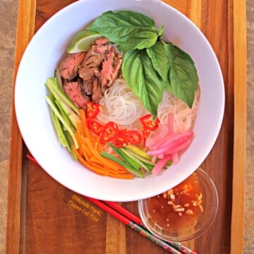 Bun Bo Xao: Vietnamese Lemongrass Beef Noodle Bowls: loaded bowl with chopsticks and nuoc cham. #vietnamesefood #bun #bunboxao #steak #lemongrass #ricenoodles @FlippedOutFood