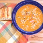 Crockpot Ham Split-Pea Soup overhead shot with the requisite hunk of crusty bread. #slowcooker #crockpot #splitpeasoup #healthyeating #flippedoutfood @FlippedOutFood
