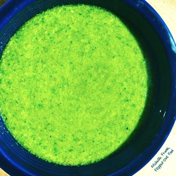 Garlic Scapes Pesto Recipe: the sauce in a blue bowl. #pesto #italianfood #seasonalfood #seasonalingredients #healthyfood #flippedoutfood @FlippedOutFood