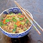 Leftover vegetable fried rice: side view. Fried rice is great way to clear out the refrigerator: use up your leftover rice, extra veggies, and even leftover cooked meat. #leftovers #friedrice #asianfood #flippedoutfood #frugalliving #budgetfriendlymeal