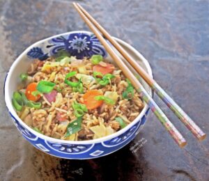 Leftover vegetable fried rice: side view. Fried rice is great way to clear out the refrigerator: use up your leftover rice, extra veggies, and even leftover cooked meat. #leftovers #friedrice #asianfood #flippedoutfood #frugalliving #budgetfriendlymeal