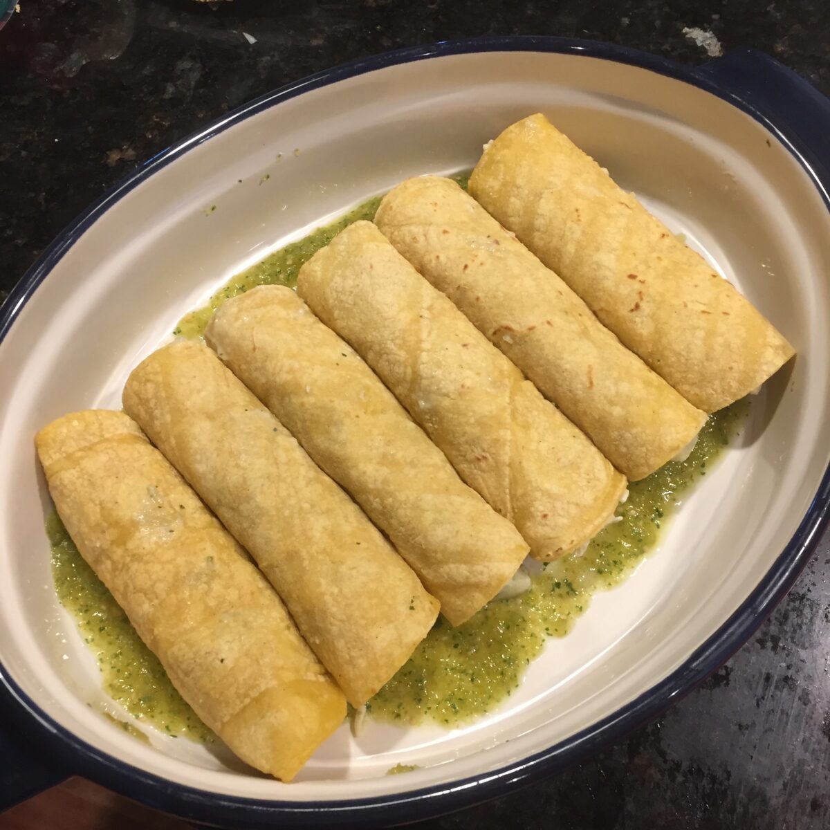 Rolled enchiladas in a baking dish