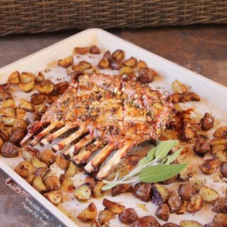 The finished Roast Rack of Lamb-Potato Traybake, ready to serve, garnished with a sprig of sage.
