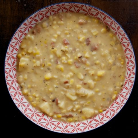 Cheesy Sweet Corn Chowder in a red and white bowl.