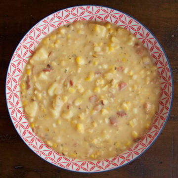 Cheesy Sweet Corn Chowder is creamy and delicious, with amazing sweet corn flavor because we start by simmering corn cobs in the broth. In the pictured bowl of chowder, you can see corn kernels, bits of bacon, and potatoes nestled in the creamy broth.