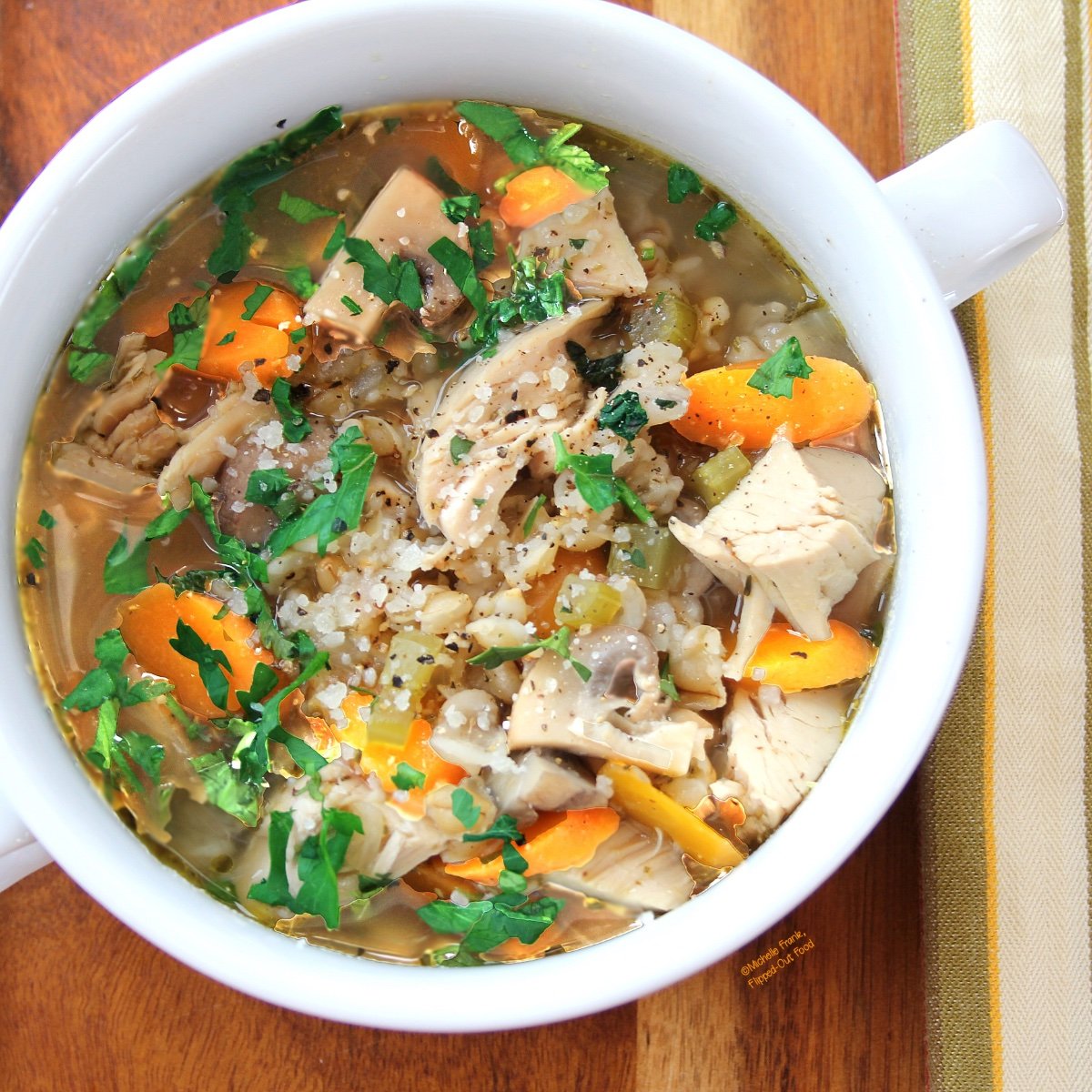 Easy Soups for Fall: Soul-Warming Barley Chicken and Vegetable Soup in a white, 2-handled bowl set on a wooden tray.