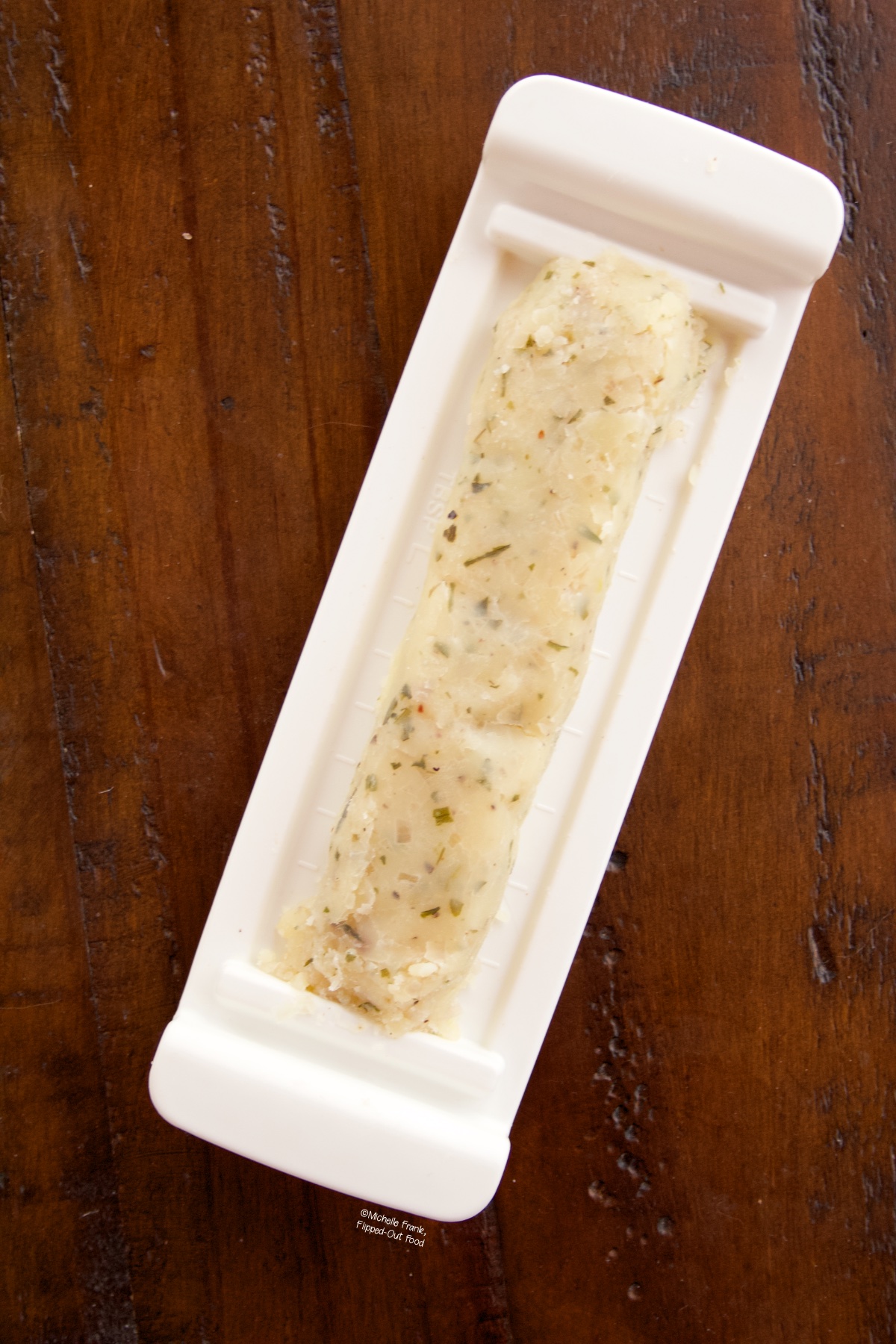 Image of chilled Compound Herb Butter in butter tray.  Awaiting to be added to reverse seared steaks.