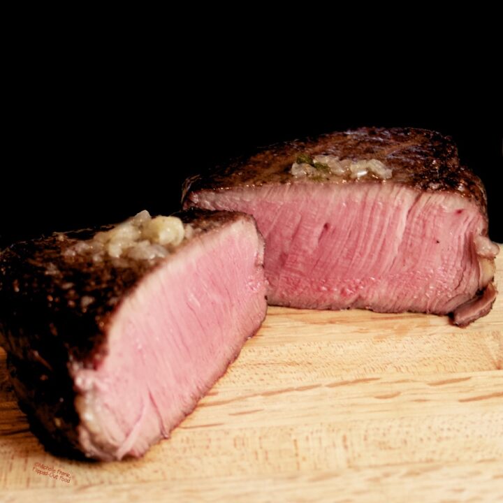 Reverse-Sear Filet Mignon Steak: a side view of one steak cut in half to show the perfect medium-rare interior.