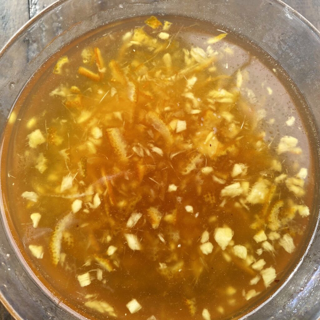 Orange-Bourbon Ham Glaze in a clear glass ramekin.