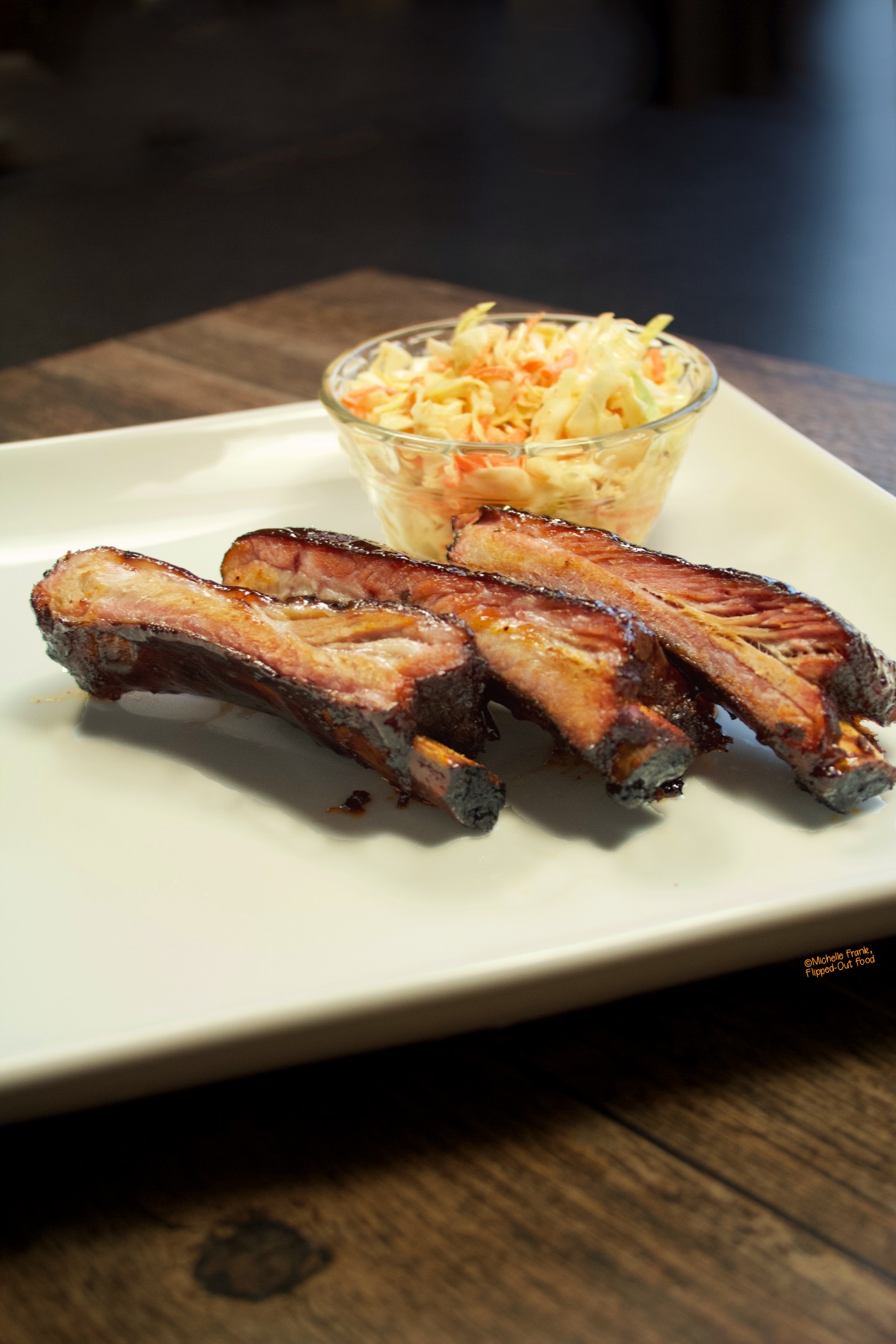 Three perfectly smoked ribs, fresh off the charcoal grill, served with coleslaw.