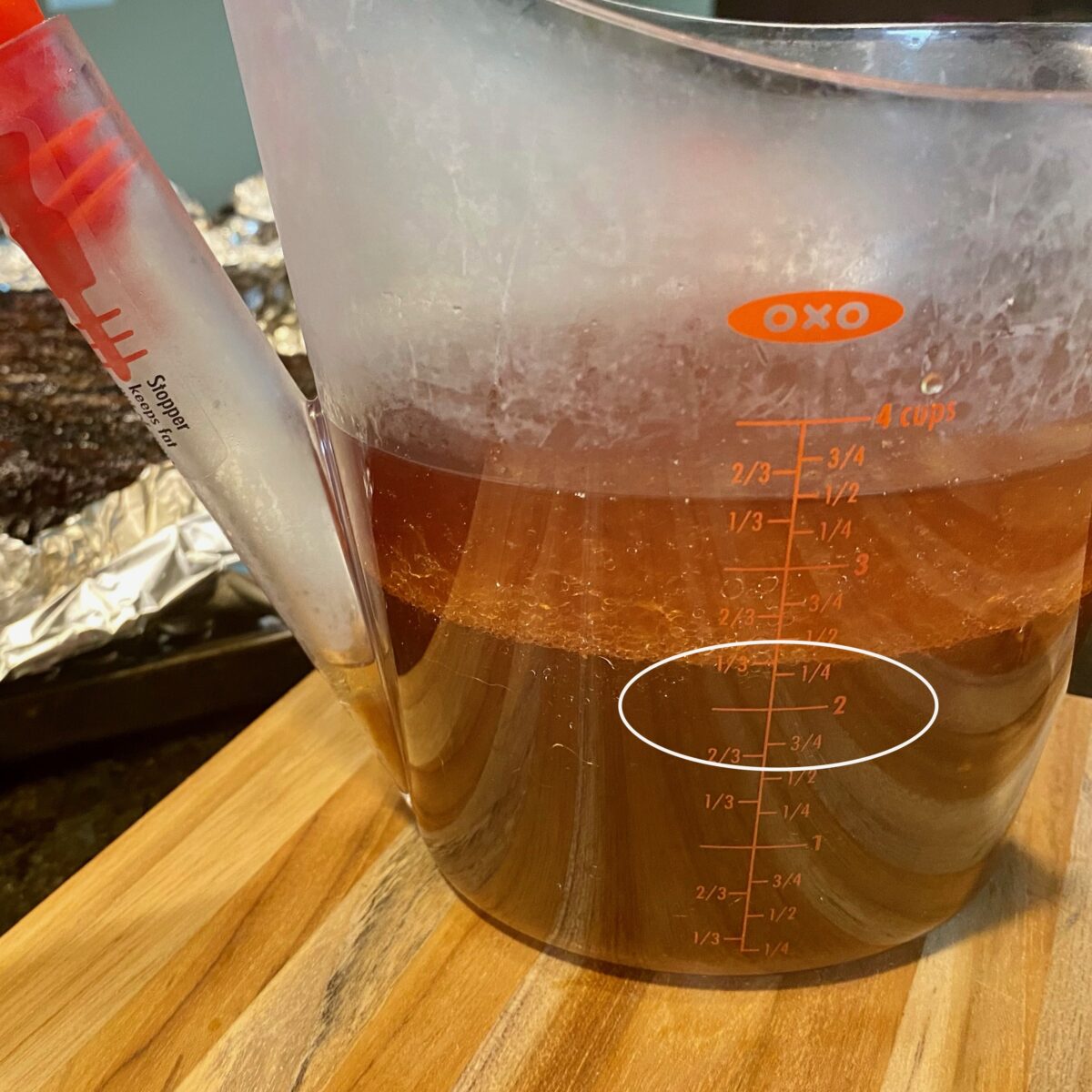 Measuring cup showing how we captured over 2 cups of broth from this 14 pound smoked brisket.