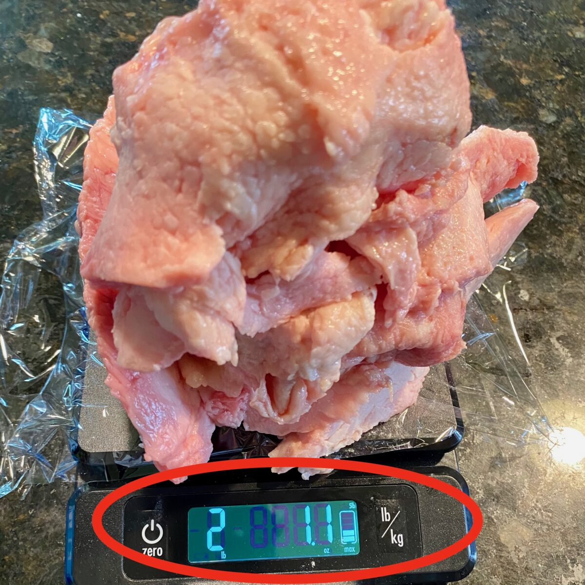 Over 2 pounds of trimmed fat placed on a scale that was removed from a brisket after prepping it.