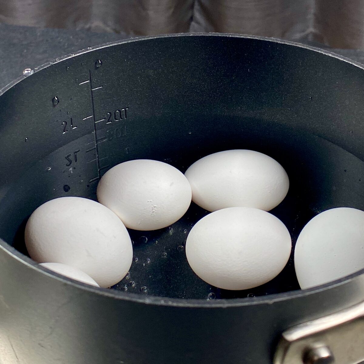 Side view showing water level one inch above the eggs while in a saucepan.
