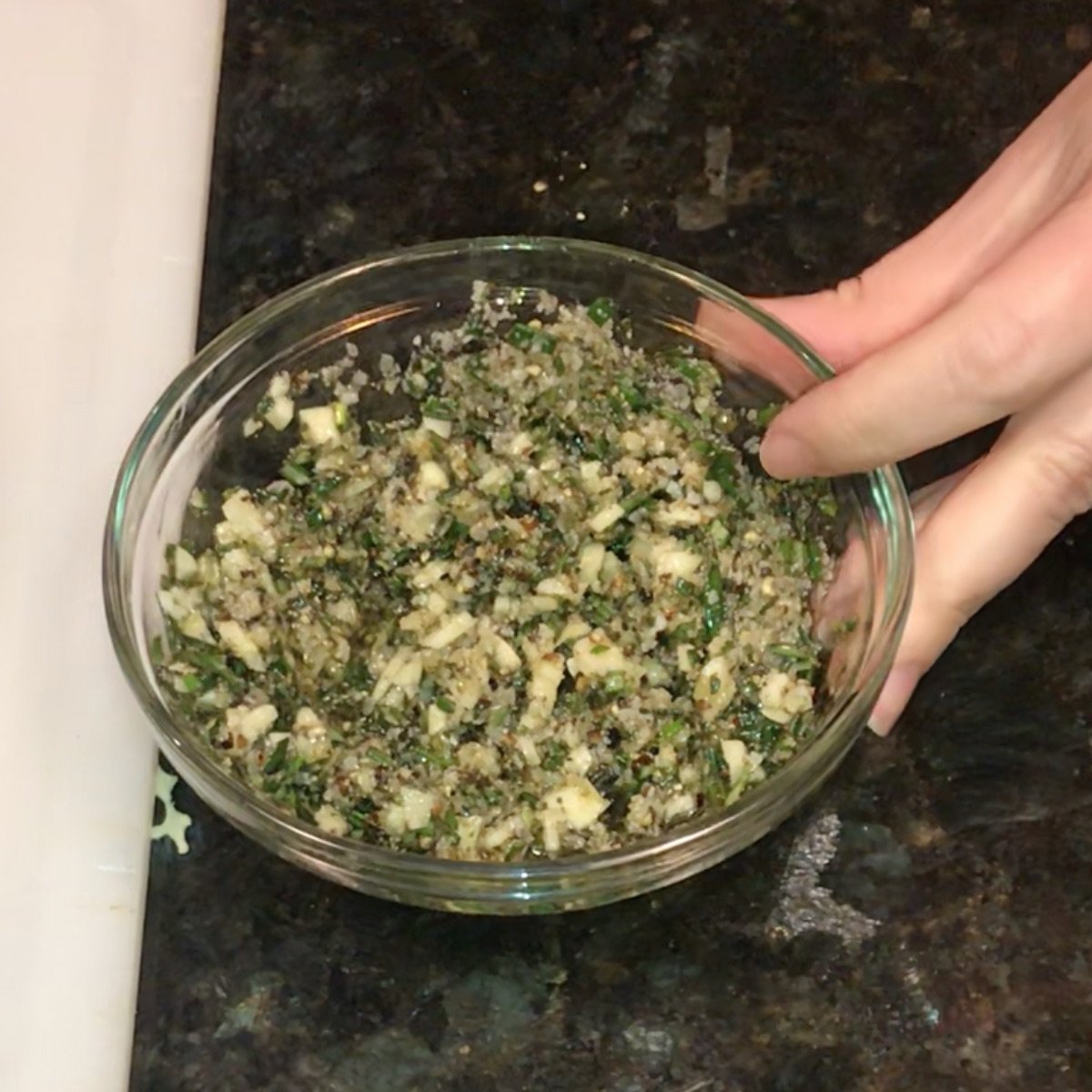 Rosemary, garlic, olive oil, salt, and pepper, mixed in a ramekin and ready to rub onto the rib roast.