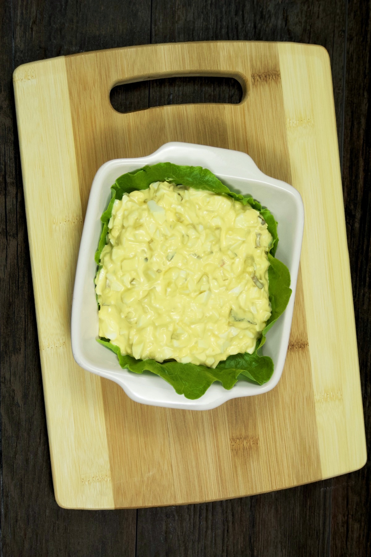 A platter of egg salad served atop fresh Bibb lettuce.
