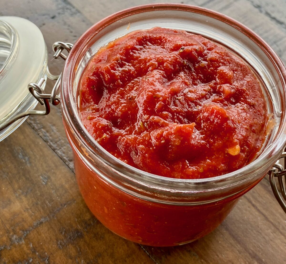 Zesty pizza sauce added to a resealable jar for future use.