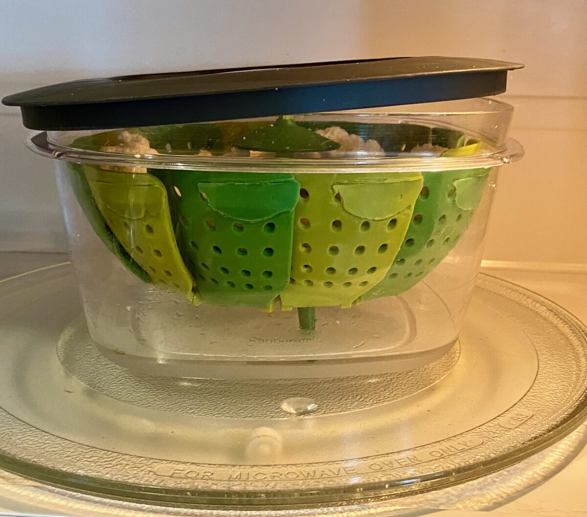 Side view of microwavable steamer inside a microwave.