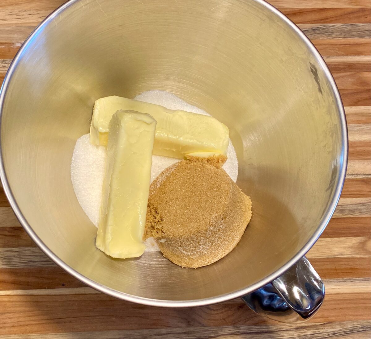 Butters and sugar in the bowl of a stand mixer.