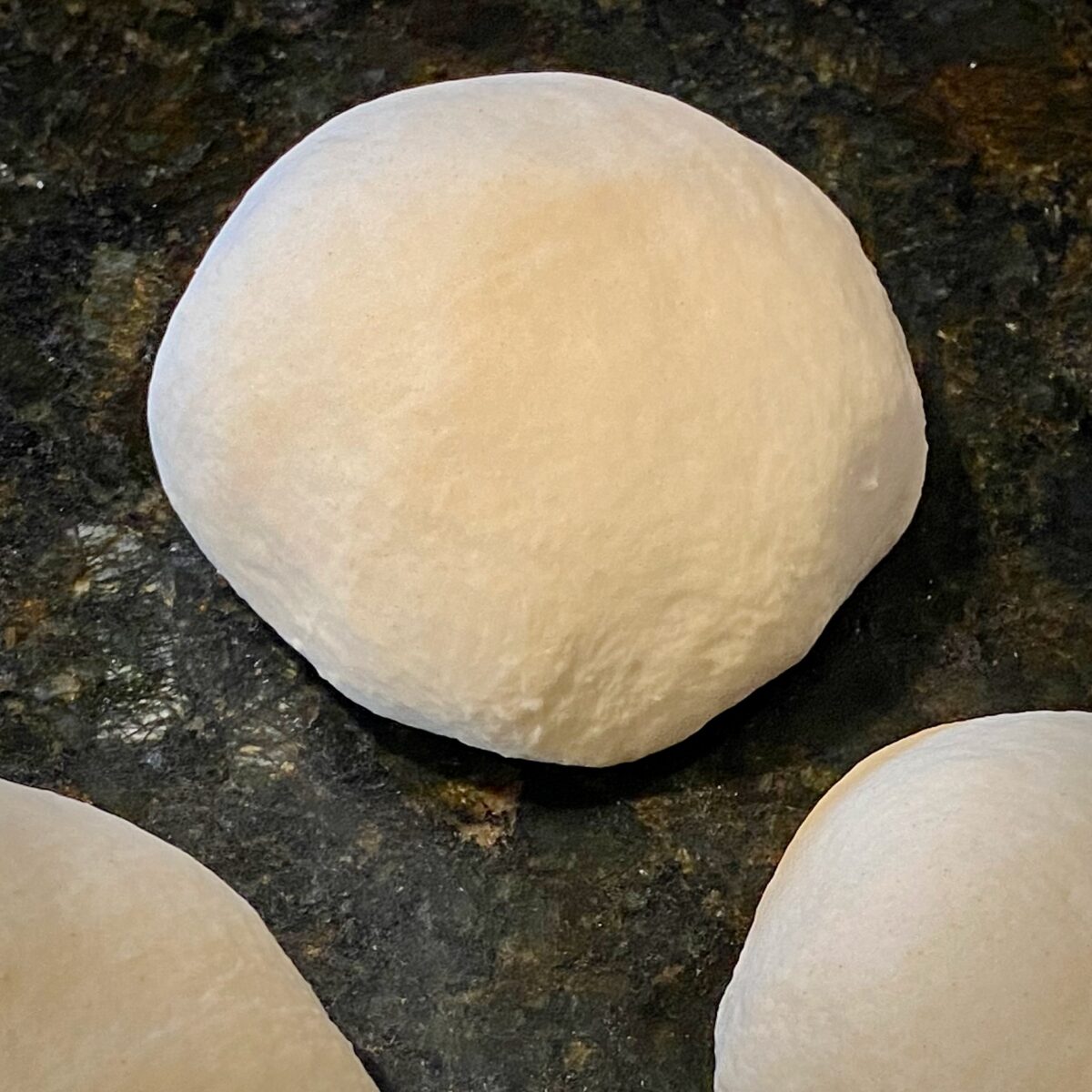 Top view of a formed pizza dough ball.