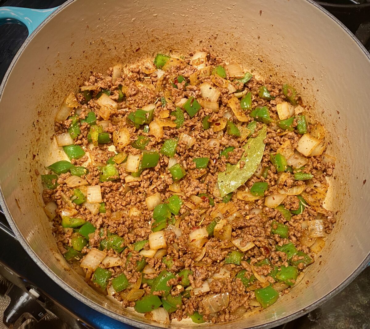 Top view of browned ground beef with onions and green peppers and all the goulash spices added.