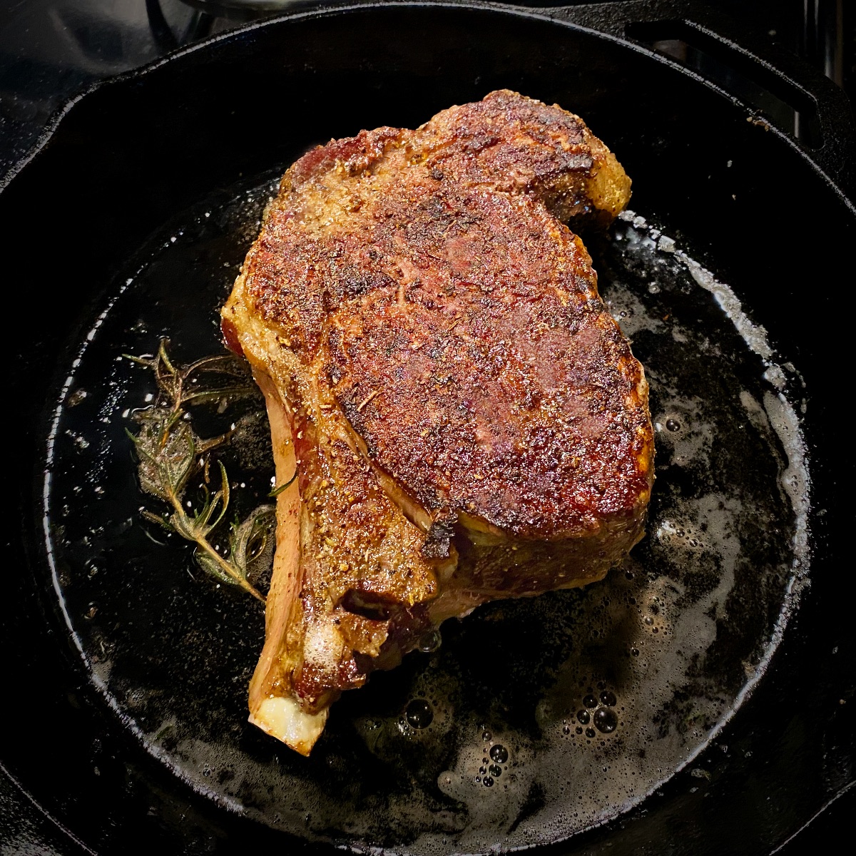 Perfectly reverse seared ribeye in a hot cast iron skillet
