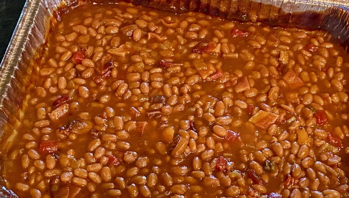 Smoked baked beans in a disposable metal pan.