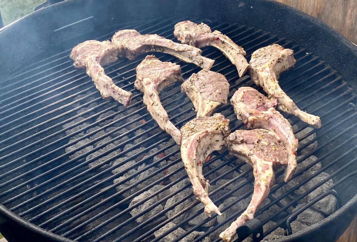 Lamb chops added to the grill, with at least one inch of space between each chop.