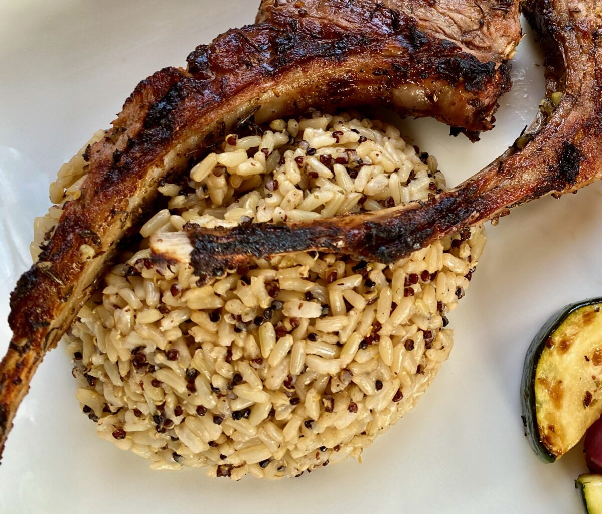 Top view of quinoa and brown rice in a white plate.