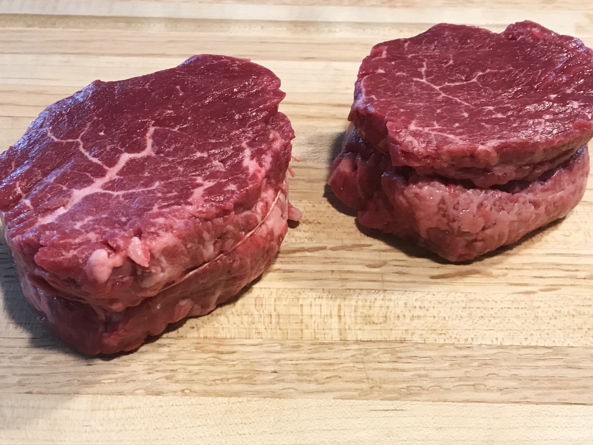Two filet mignon steaks resting at room temperature