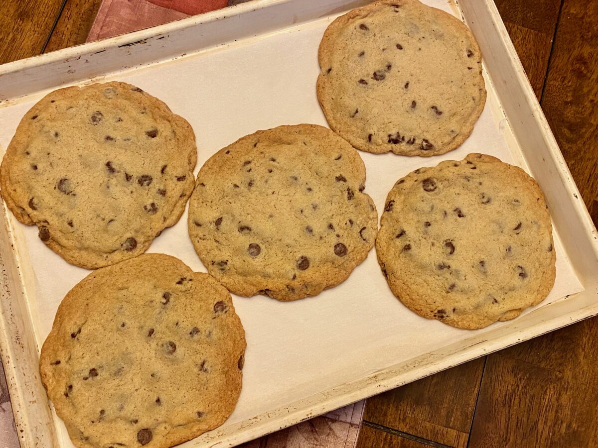 Finished monster chocolate chip cookies, cooling on the baking sheet.