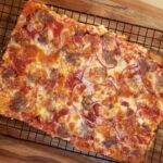 Homemade Pan Pizza cooling on a wire rack.